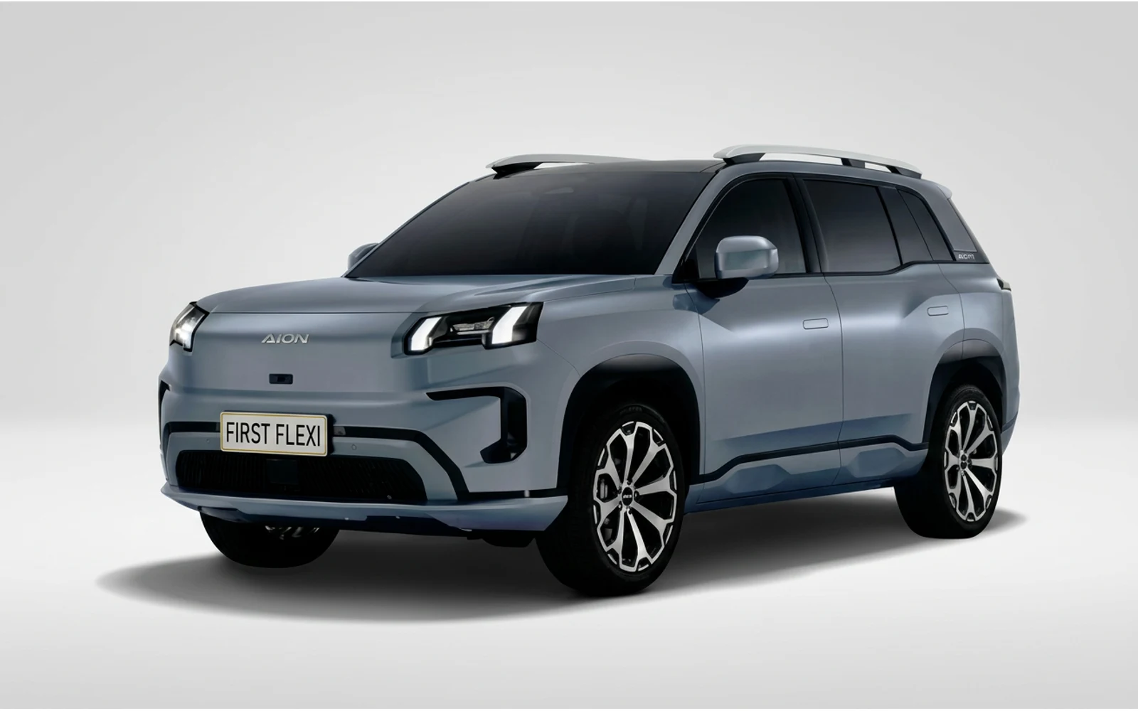 Silver Aion V SUV viewed from a front 3/4 angle against a black background.
