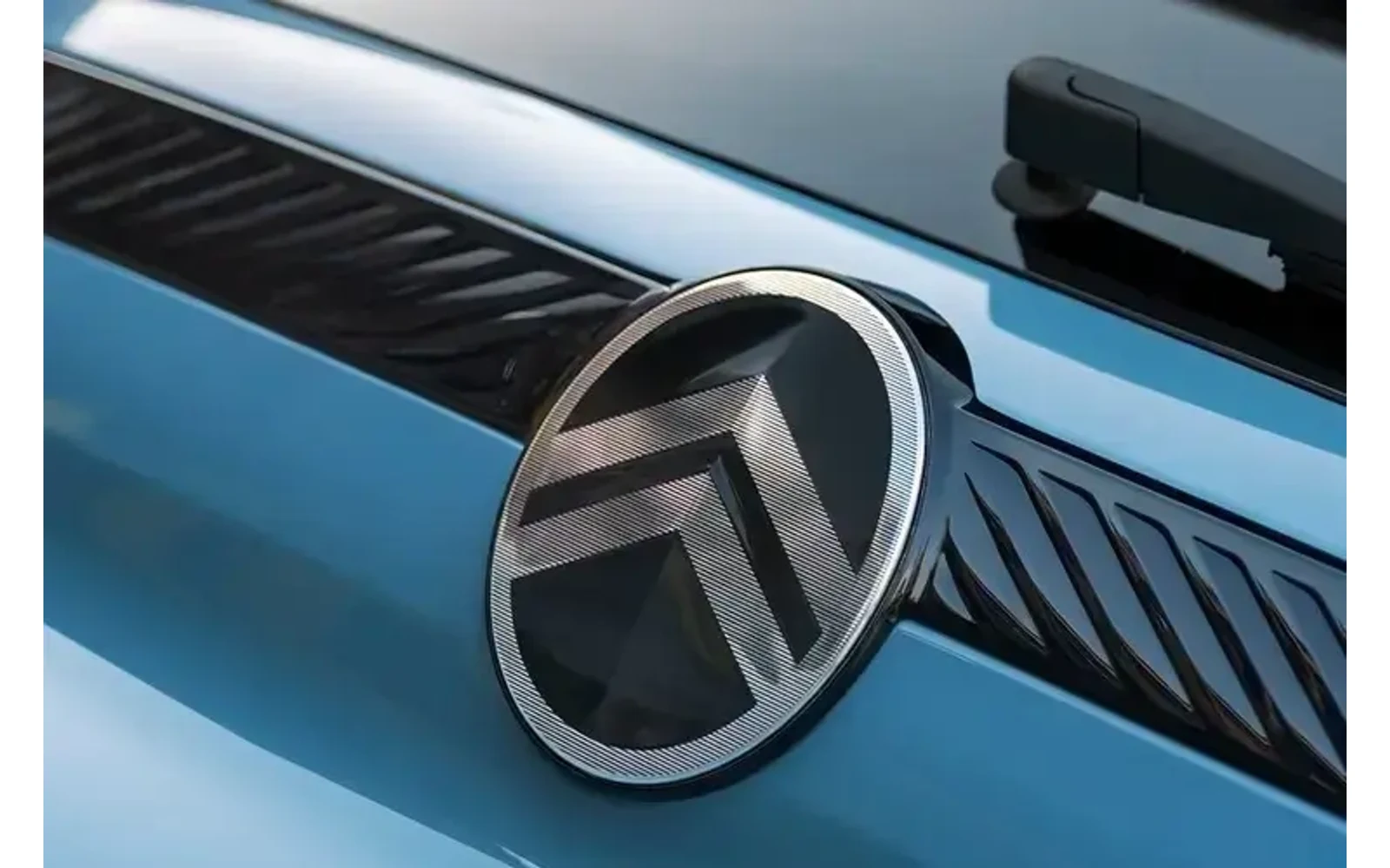 Close-up of the blue Citroen C3 logo on the hood.