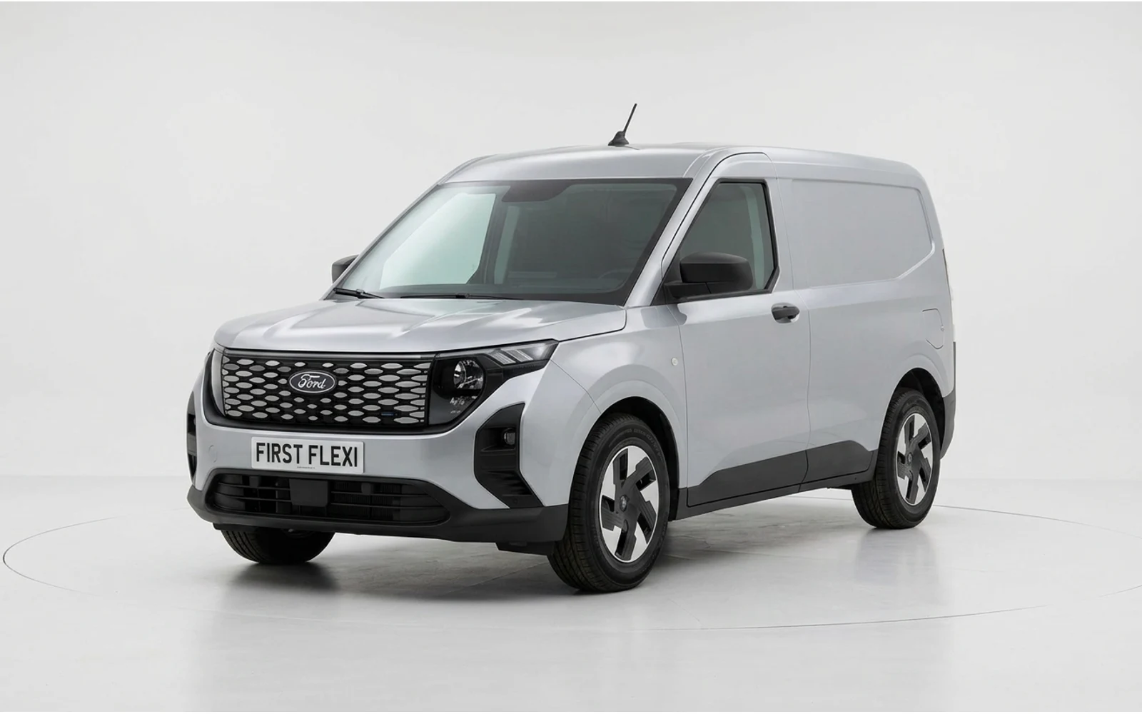 Silver Ford E-Transit Courier van seen from a three-quarter front view.