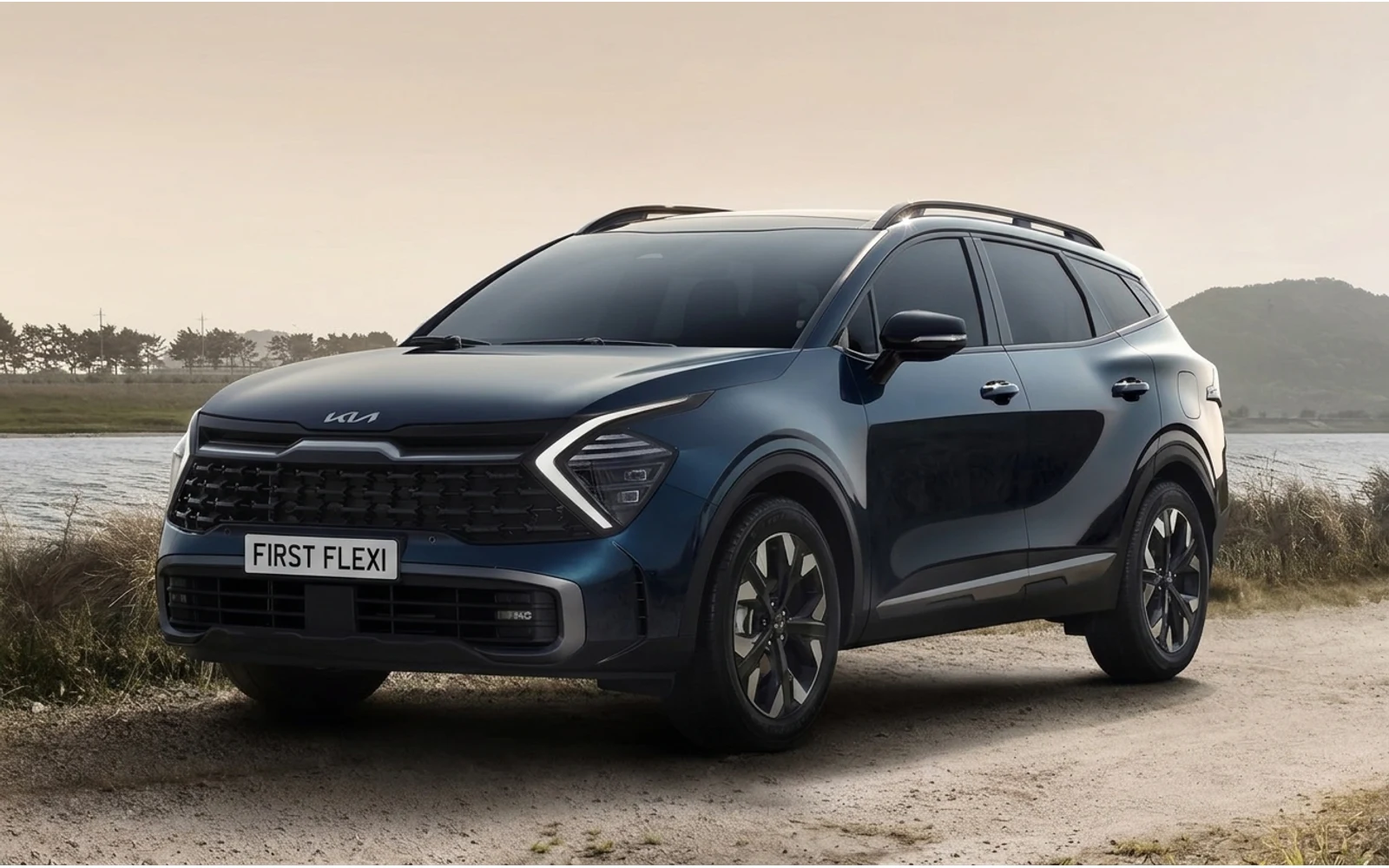 A dark blue Kia Sportage is parked by a body of water, viewed from the front quarter.