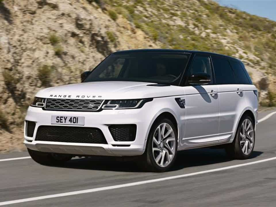 Range Rover Sport driving next to a hill