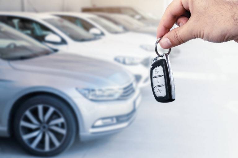 man holding new lease car keys