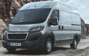 large van driving on a dirt road