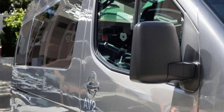 A modern van parked on a city street.