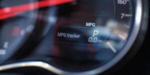 Car dashboard displaying fuel efficiency data.
