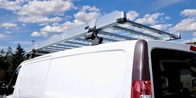 Van with a roof rack against a clear sky.