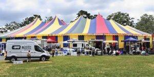 Van parked beside event marquee.
