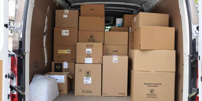 A loaded van interior packed with boxes.