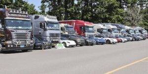 Mixed diesel and electric vehicles parked side-by-side.