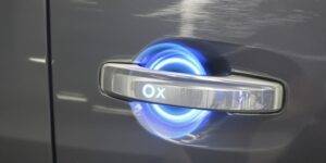 Modern van door handle with glowing blue light.