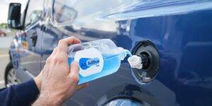A clean diesel van with AdBlue fluid being poured.