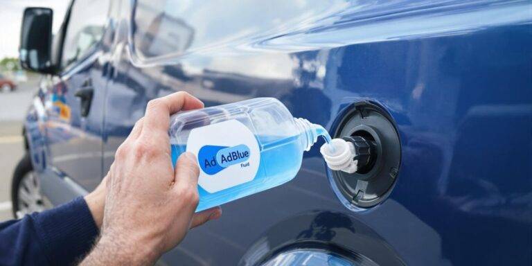 A clean diesel van with AdBlue fluid being poured.