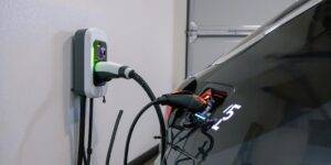 Electric vehicle charging overnight in a garage.